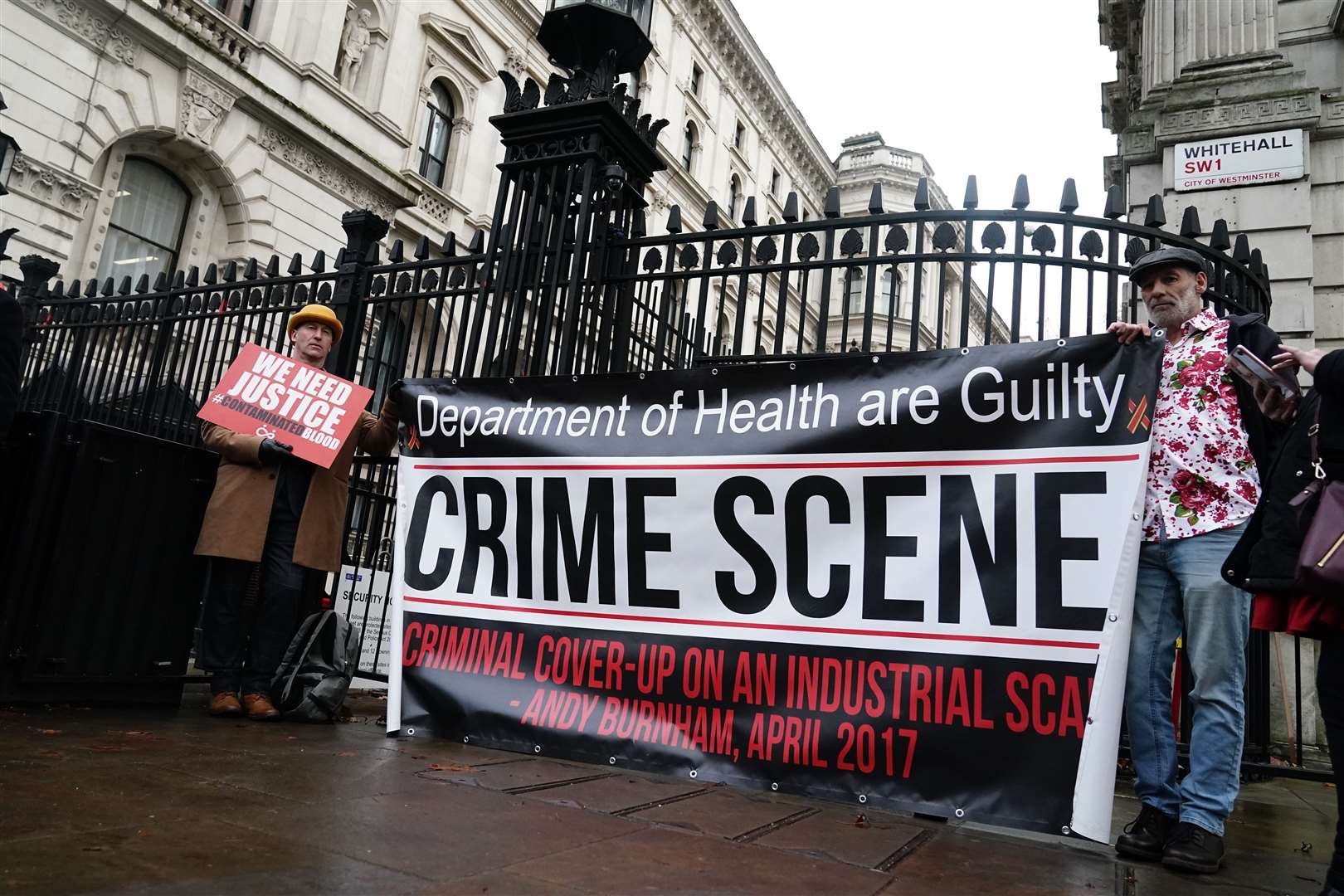Campaigners protest outside Downing Street (PA)