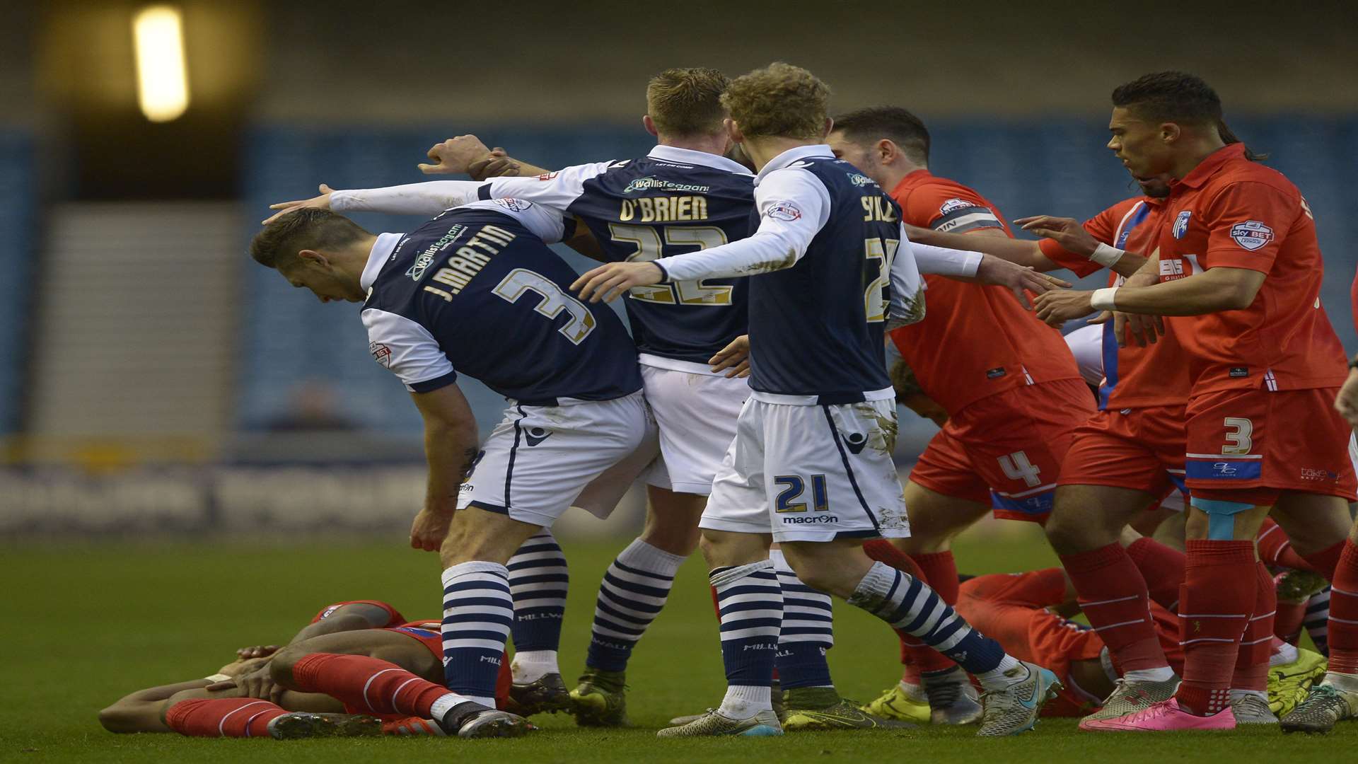 Gillingham players clash with Millwall at The Den Picture: Barry Goodwin