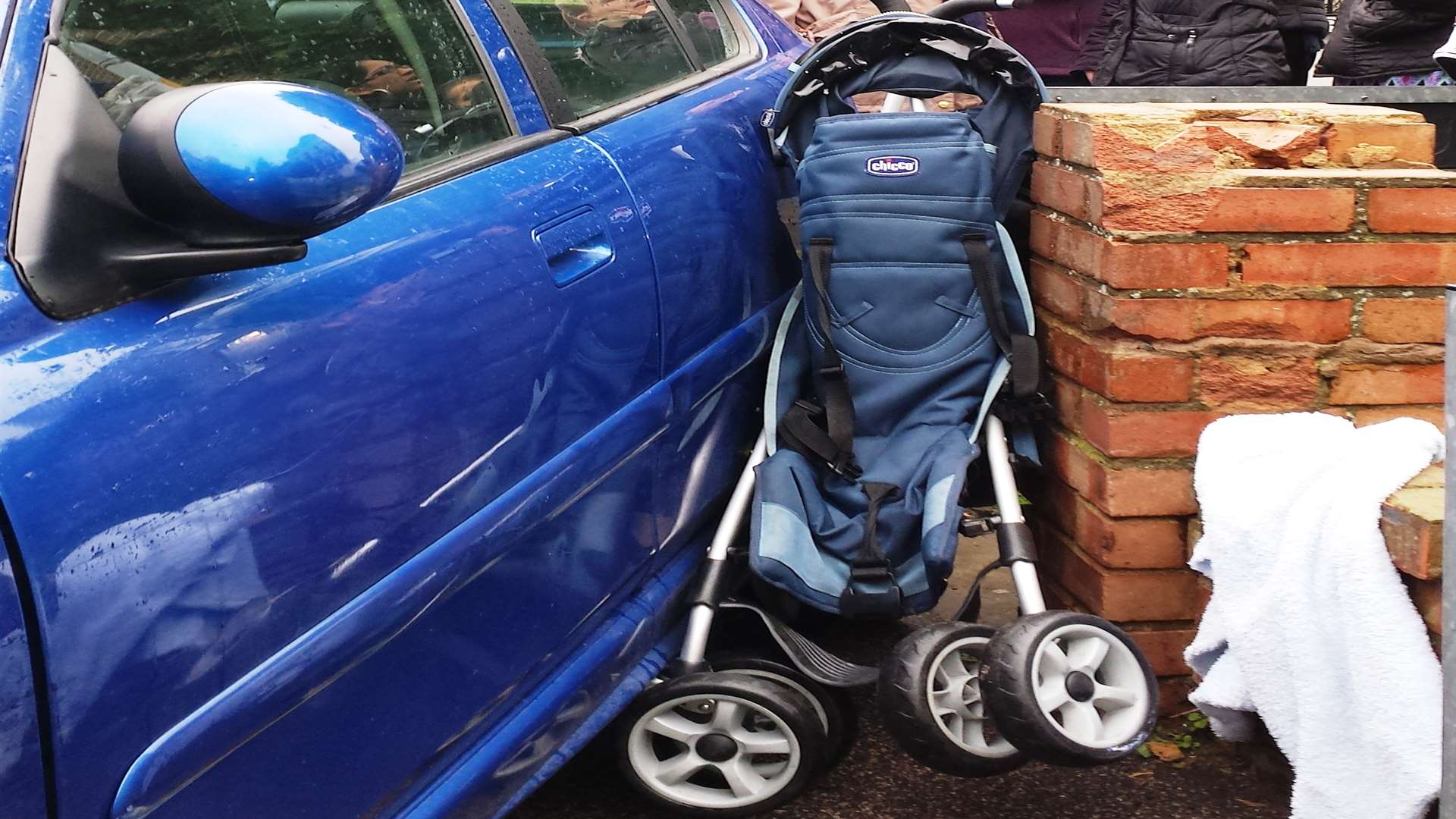 A pushchair sandwiched between a car and wall in a crash in Gravesend