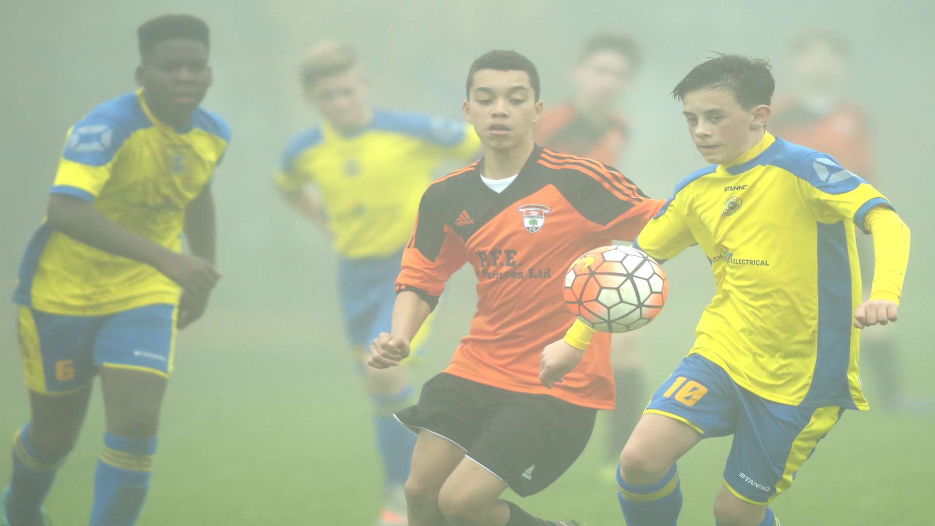 Strood 87 (yellow) and Lordswood Youth battle the fog as well as each other in Under-14 Division 1 Picture: Martin Apps