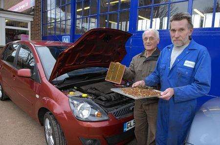 Mechanic Brian Wilkins with car owner Alan Barling and the huge hoard of nuts found blocking the engine's air filter.