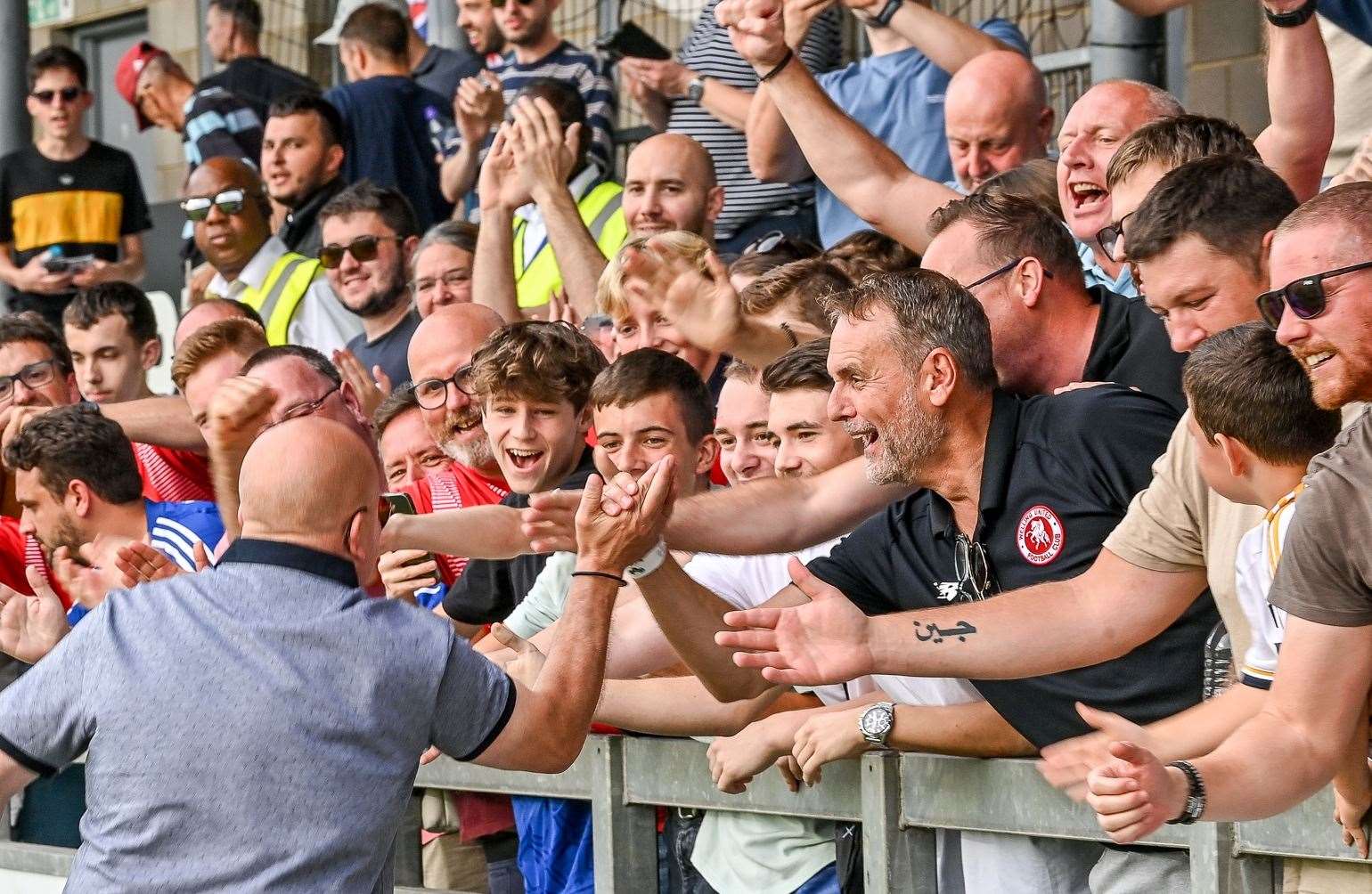 Welling manager Danny Bloor celebrates with fans at Dartford. Picture: Dave Budden