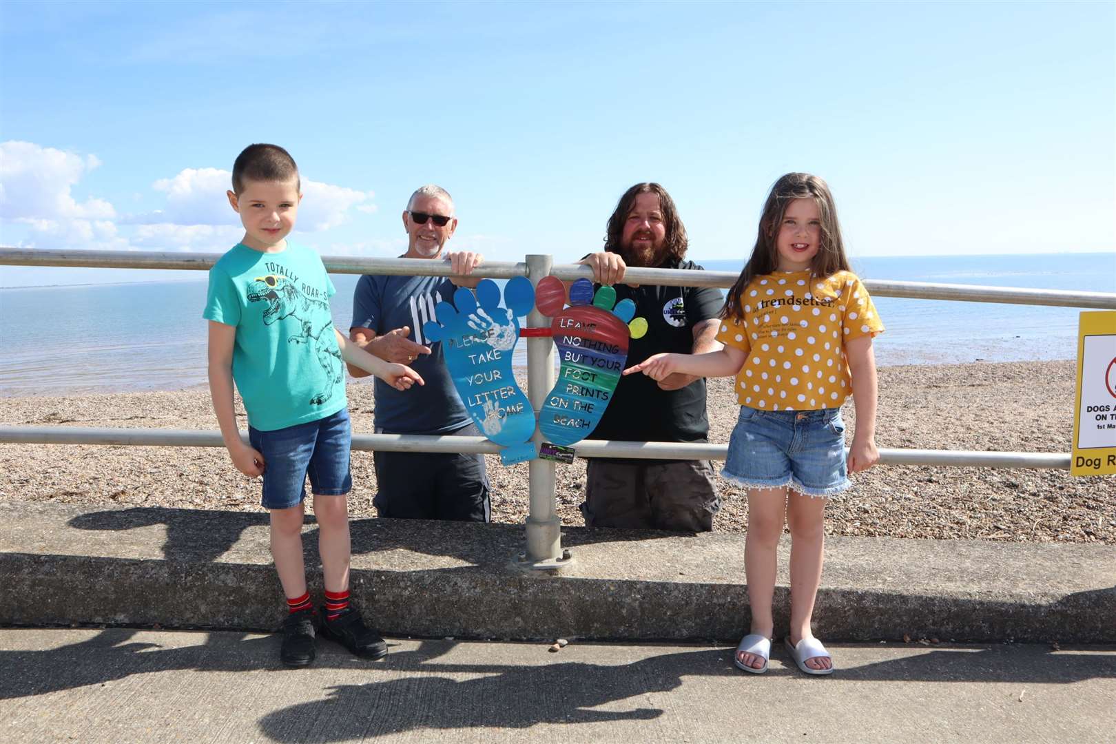 Tony Valentine, left, and Darren Hardy with two of their beach feet on the Leas, Minster, Sheppey, with seven-year-old twins Leo and Phoebe Attwood who have decorated their own pair. Picture: John Nurden (38640644)