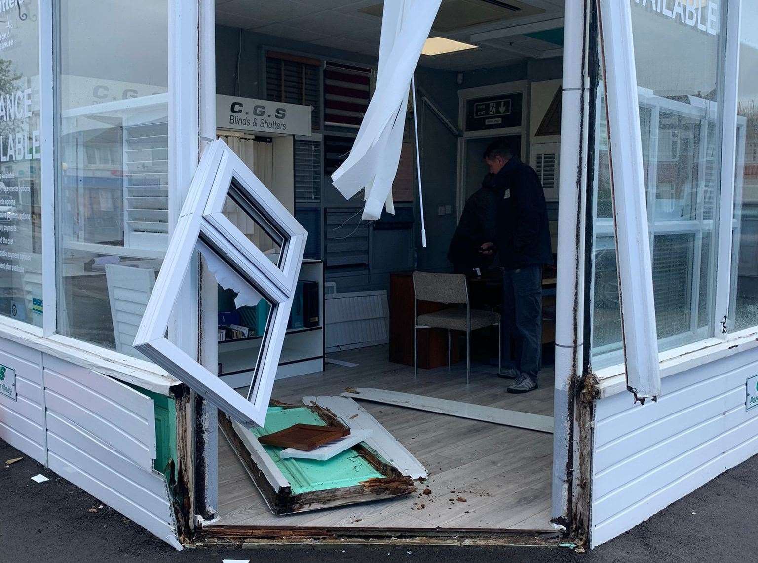 Heavy winds blew out on window and frame from the shop front of CGS Blinds and Shutters in Tankerton, near Whitstable, scattering debris into the street
