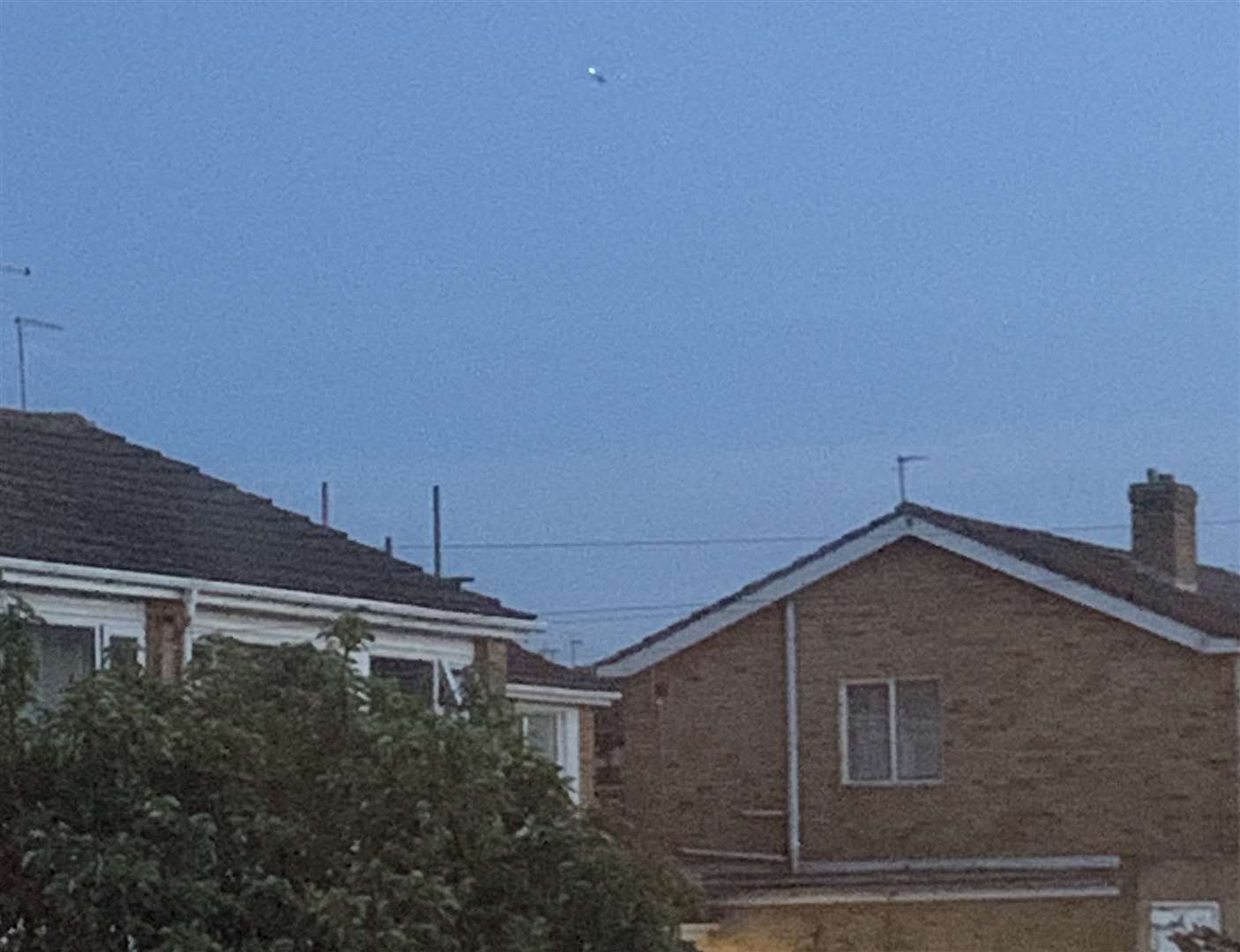 A police helicopter in the distance searching over the Mill Hill area of Deal