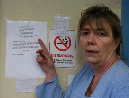 Pauline Dunnill with her poem to Dolly Knighton and other messages of support posted on shopfront. Pictures: MARY LOUIS