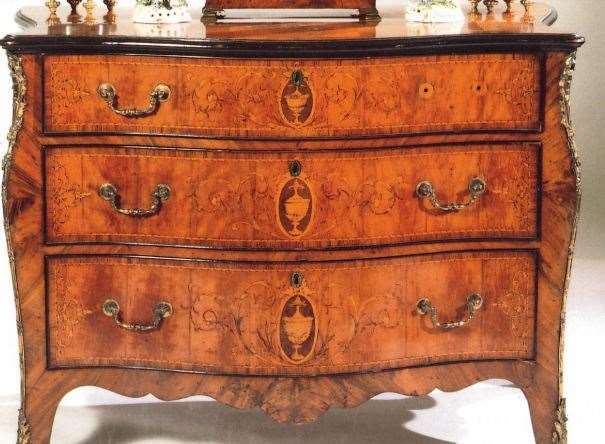A George III satinwood and Marquetry commode fetched £62,000 in 1996