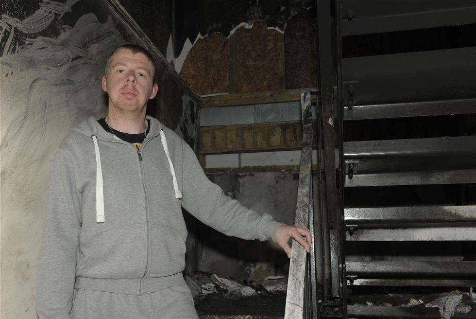 Martin Parrett in the fire damaged stairwell at Samuels Tower