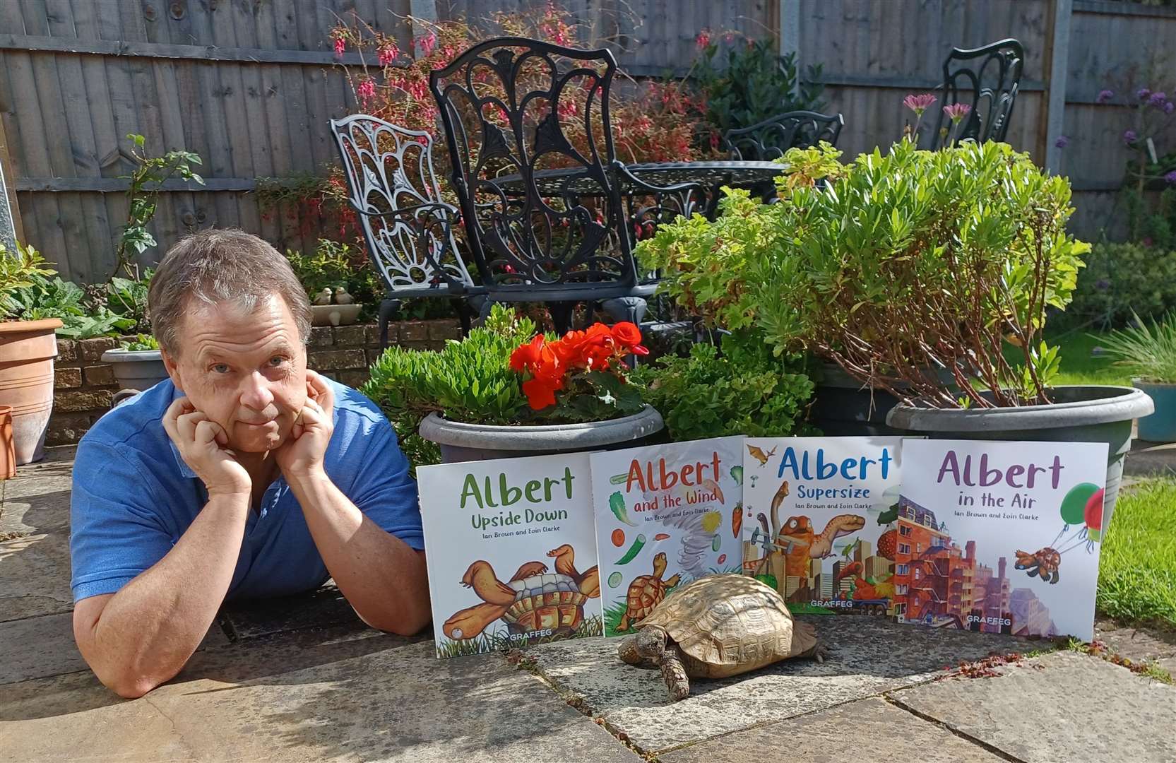 Author Ian Brown and his tortoise Albert, who is the inspiration behind Mr Brown's book series. Picture: Ian Brown
