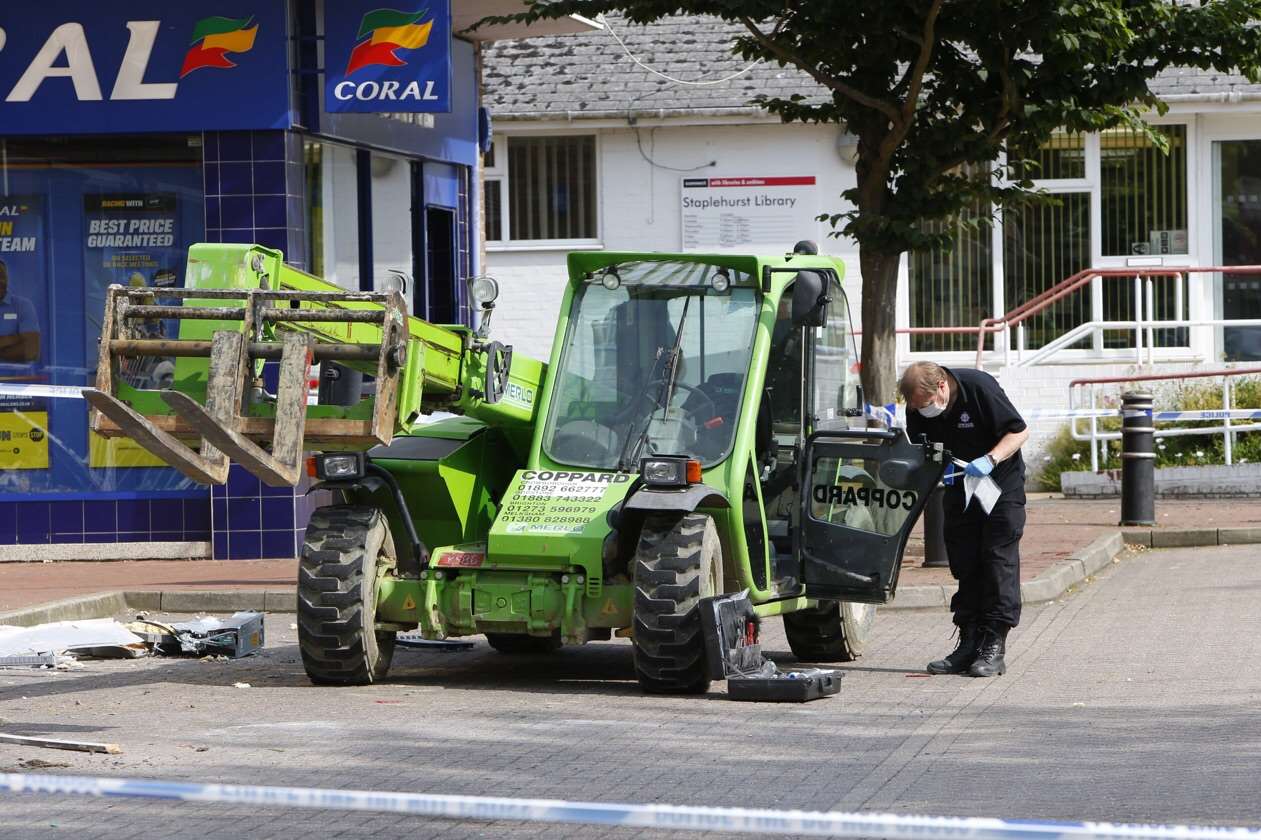 An officer examines farm machinery used in a raid on NatWest bank in Staplehurst. Picture: Andy Jones