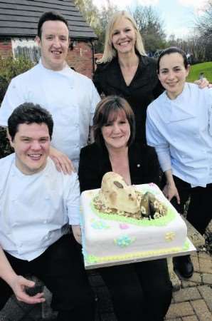 Executive Chef at the Abode Hotel Mark Rossi with Liz Baxter and Michelle Moxley of Kent Kids Miles of Smiles and fellow chef's Philip Holmes and Ana Velazquez at the presentation of the Easter cake on Wednesday. Picture:Chris Davey