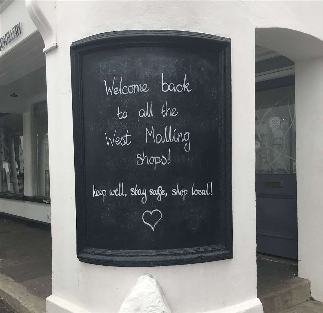 A sign welcomes shoppers back to West Malling