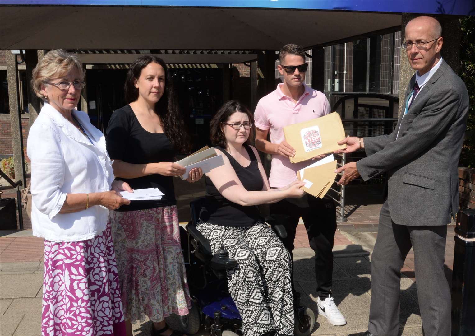 Cllr Kristine Carr, Catriona Jamison, Kate Belmonte and Cllr Martin Potter hand over petitions to Dave Harris, head of planning at Medway Council, over the proposed Pump Lane housing development. Picture: Chris Davey