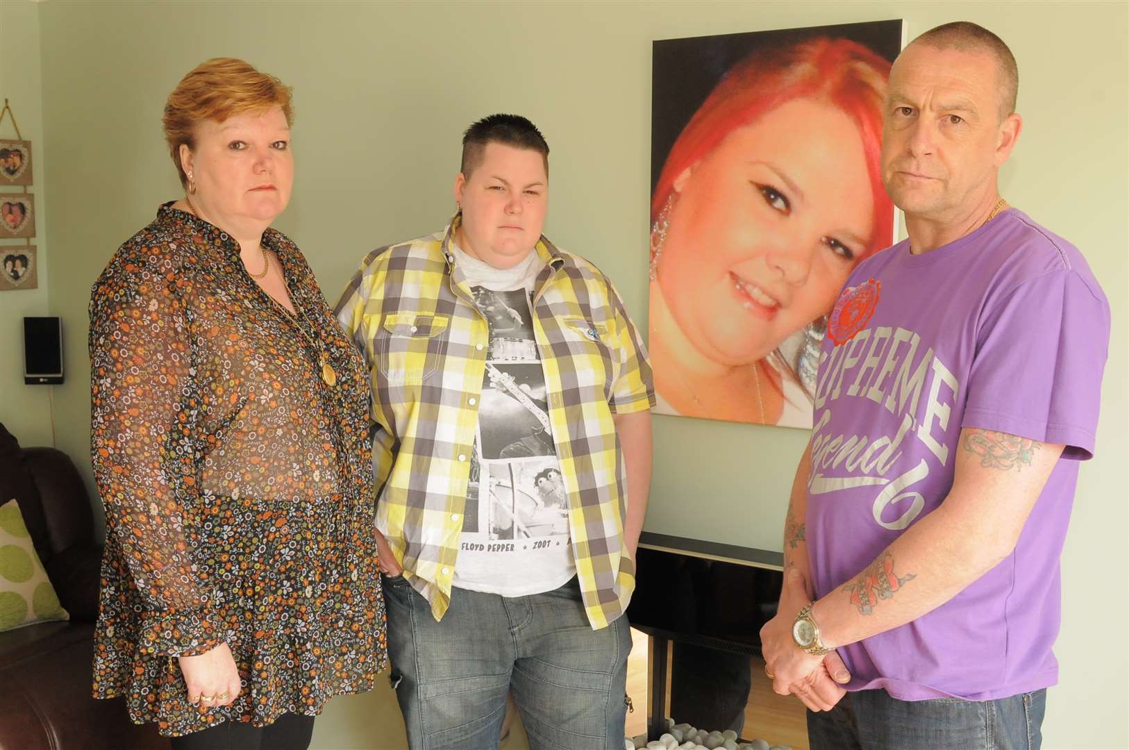 Adele Jarvis (left) with daughter Gemma and husband Mark, standing in front of a picture of Natalie Jarvis, her daughter who was killed in 2013