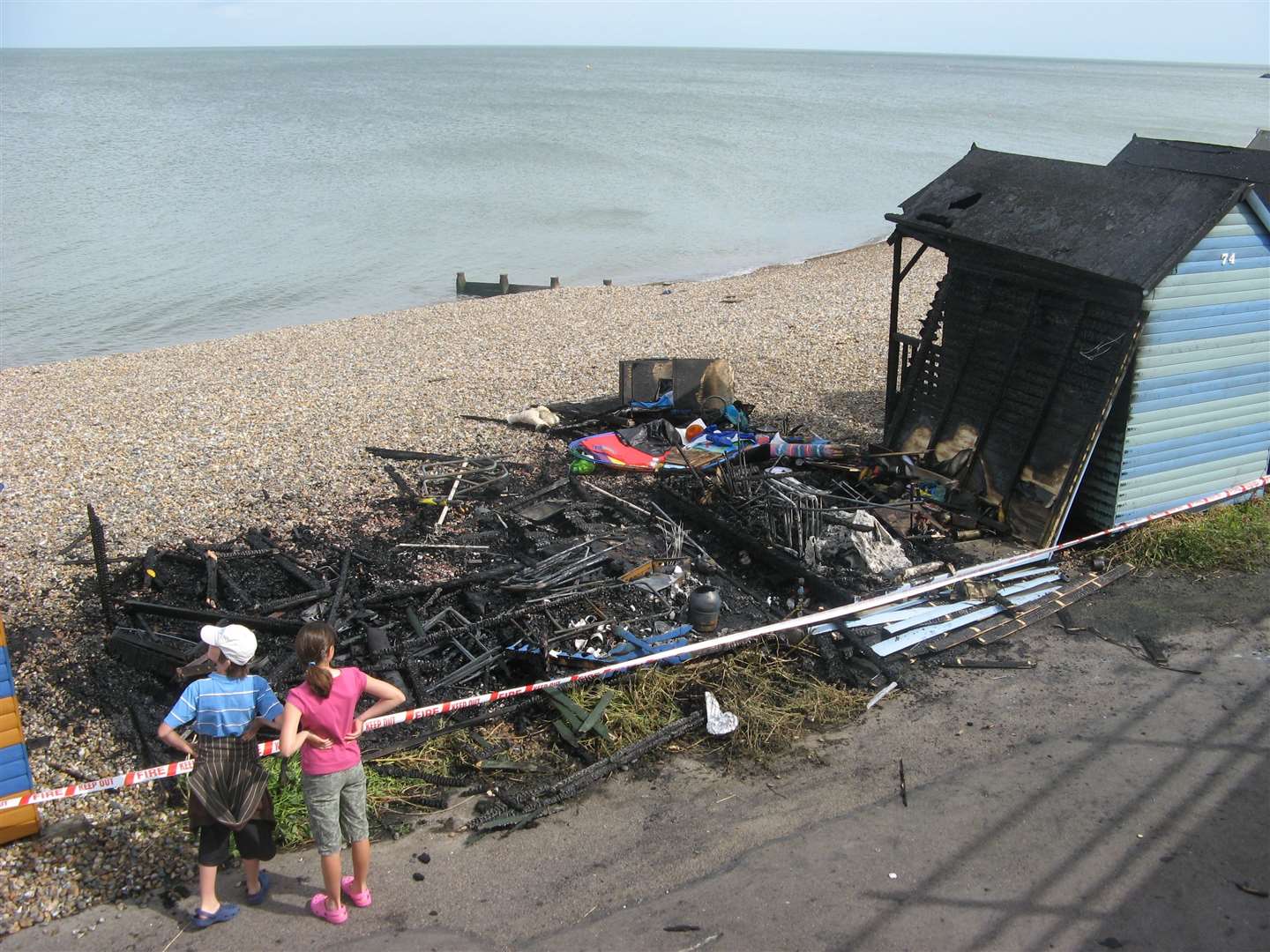 The charred remains of the beach huts which burnt down 13 years ago