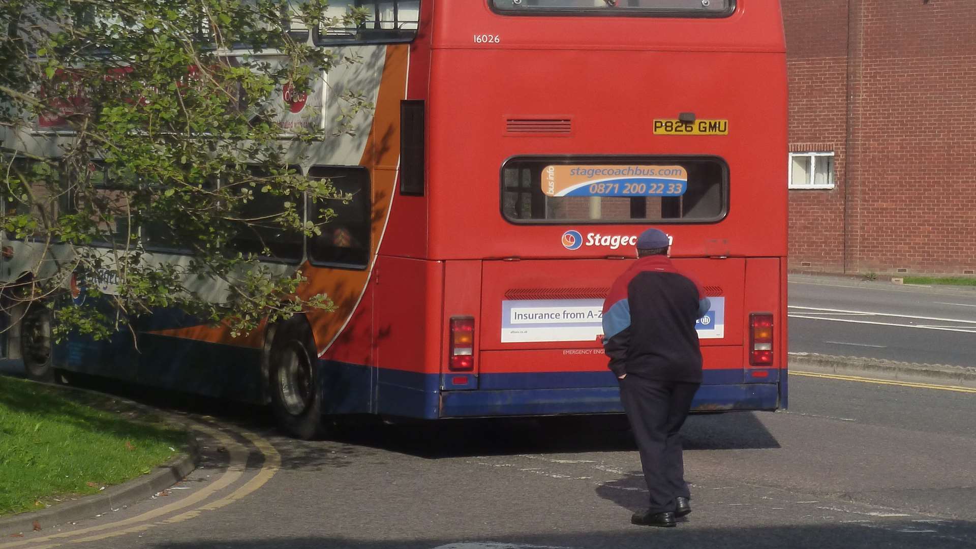 The Stagecoach bus driver inspects the damage after his tyre exploded