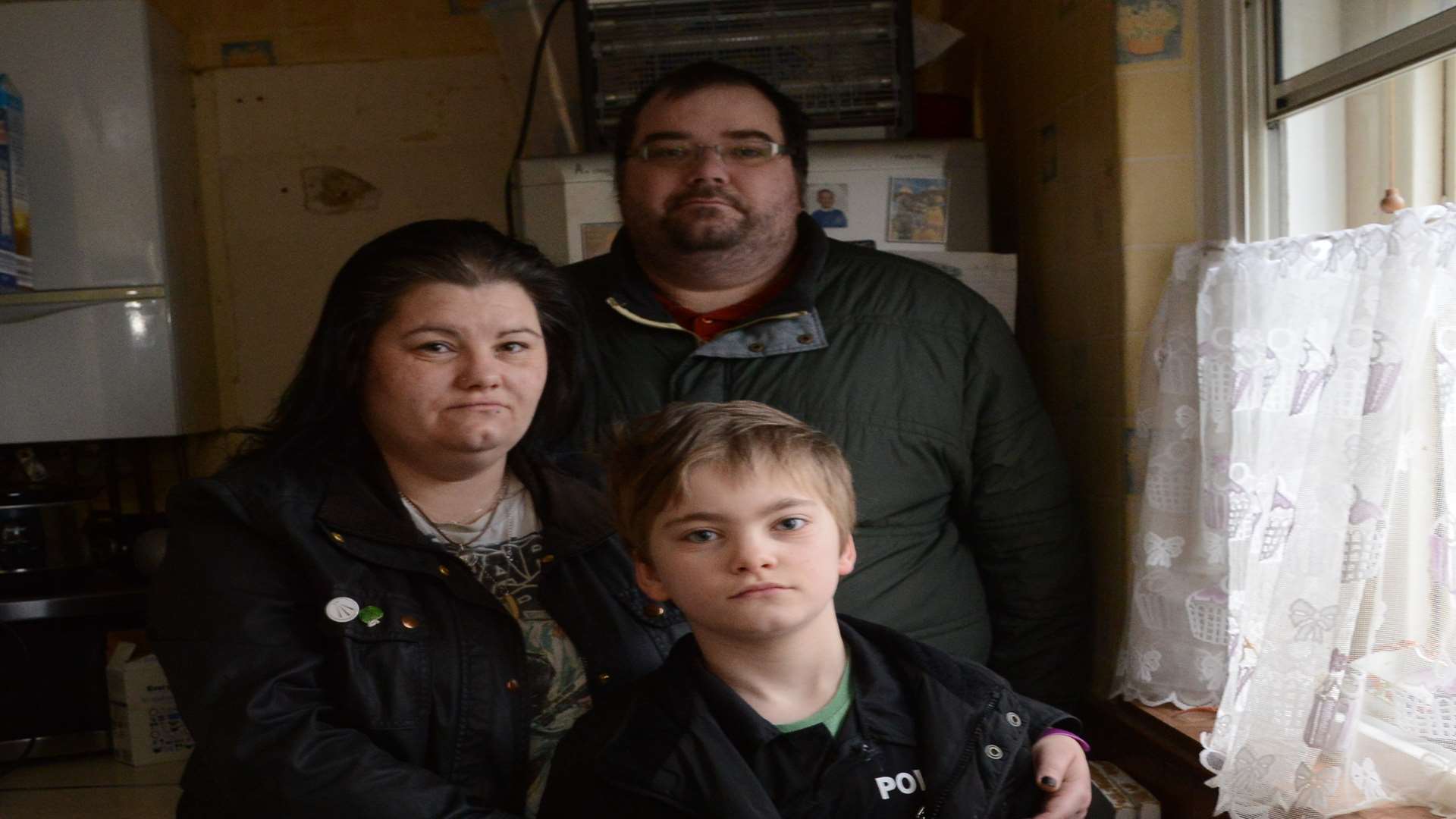 Kevin and Janine Ridgway and their son Kristion have been adding the layers in their home due to no heating or hot water. Picture: Gary Browne