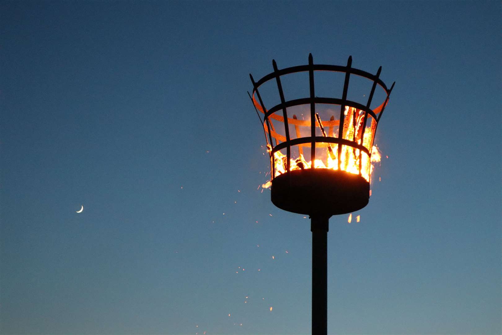 Queenborough's Platinum Jubilee Beacon ablaze at Crundall's Wharf with the moon. Picture: John Nurden
