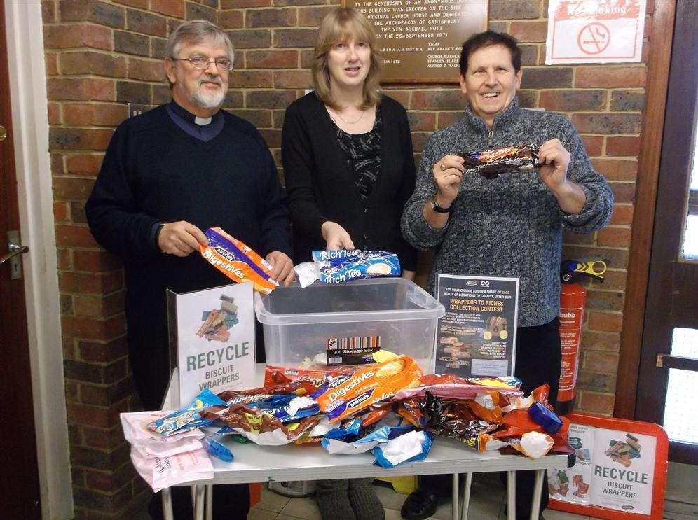 Rev Don Witts, Sara Gower and Michael Blakesley, from All Saints Church, Birchington, in Church House Hall, with some of the used biscuit wrappers they have saved from landfill as part of the Wrappers to Riches Collection Contest