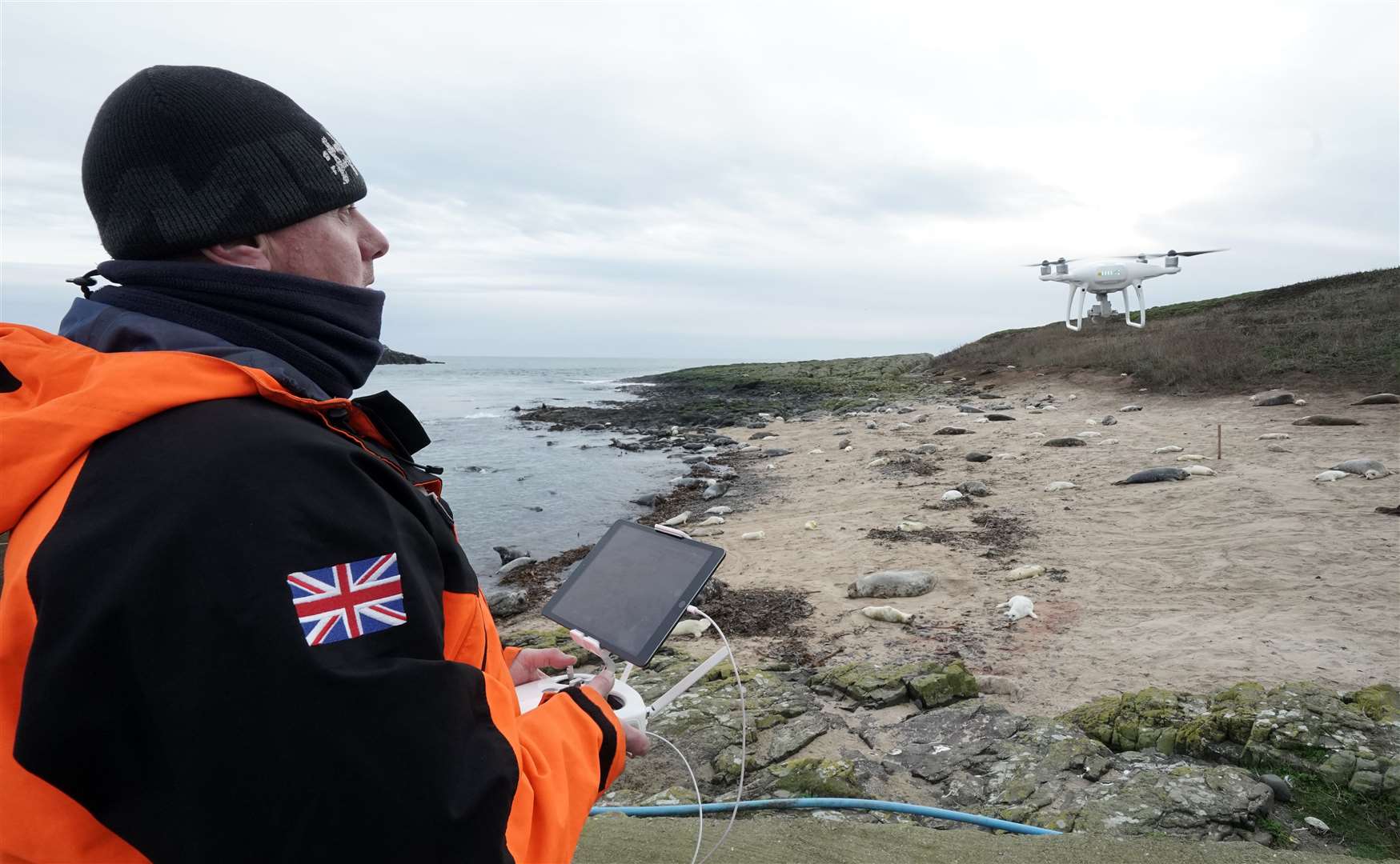 Ritchie Southerton flies a drone flying over seals on the Farne Islands (Owen Humphreys/PA)