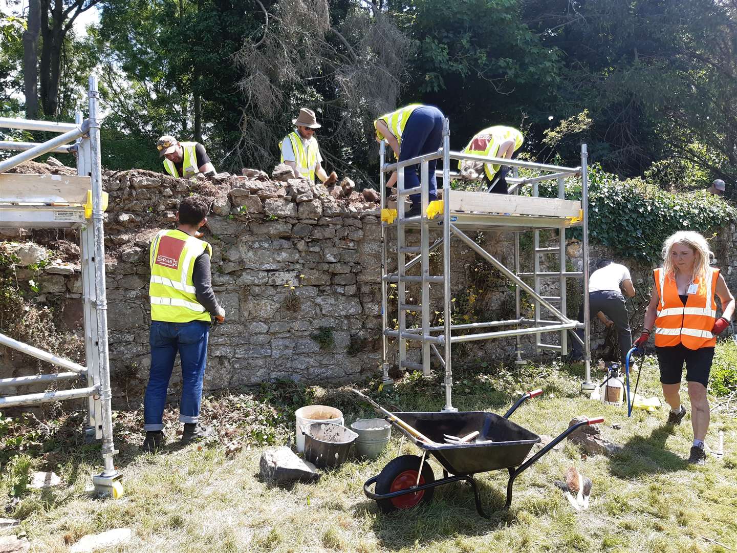 The team soft-capping a stone wall in the gardens at Boxley