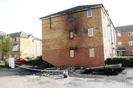 The charred remains of a bin shed destroyed next to flats in Dunlop Close, Dartford