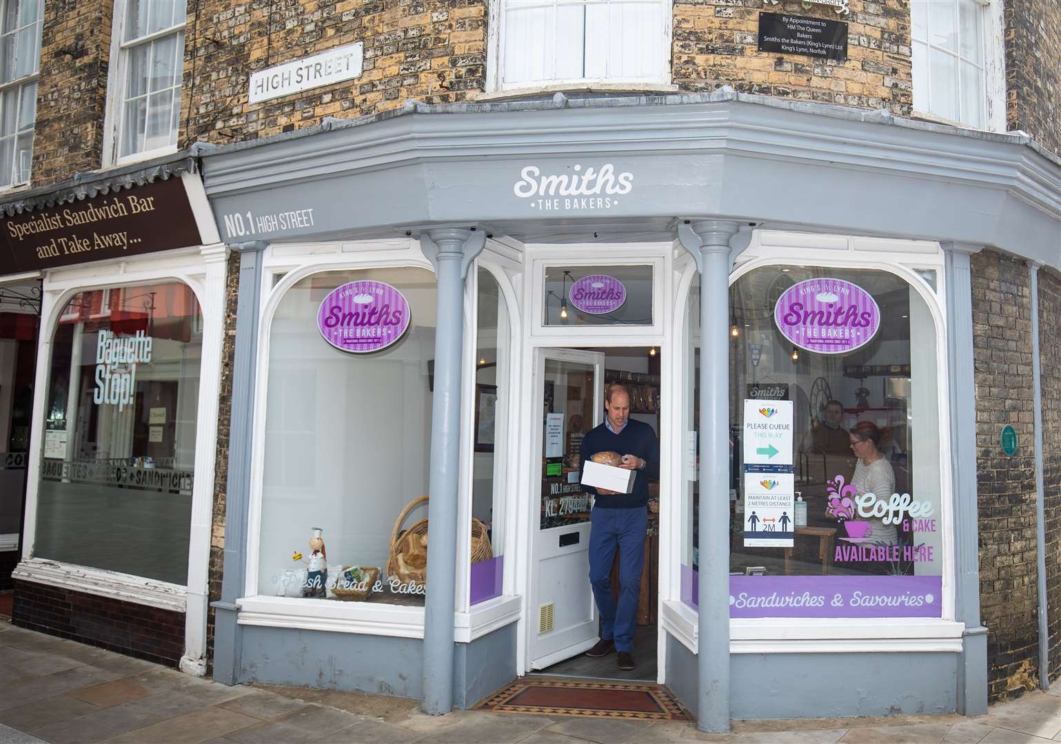 Fully stocked with baked goods and his cake, William leaves Smiths (Aaron Chown/PA)