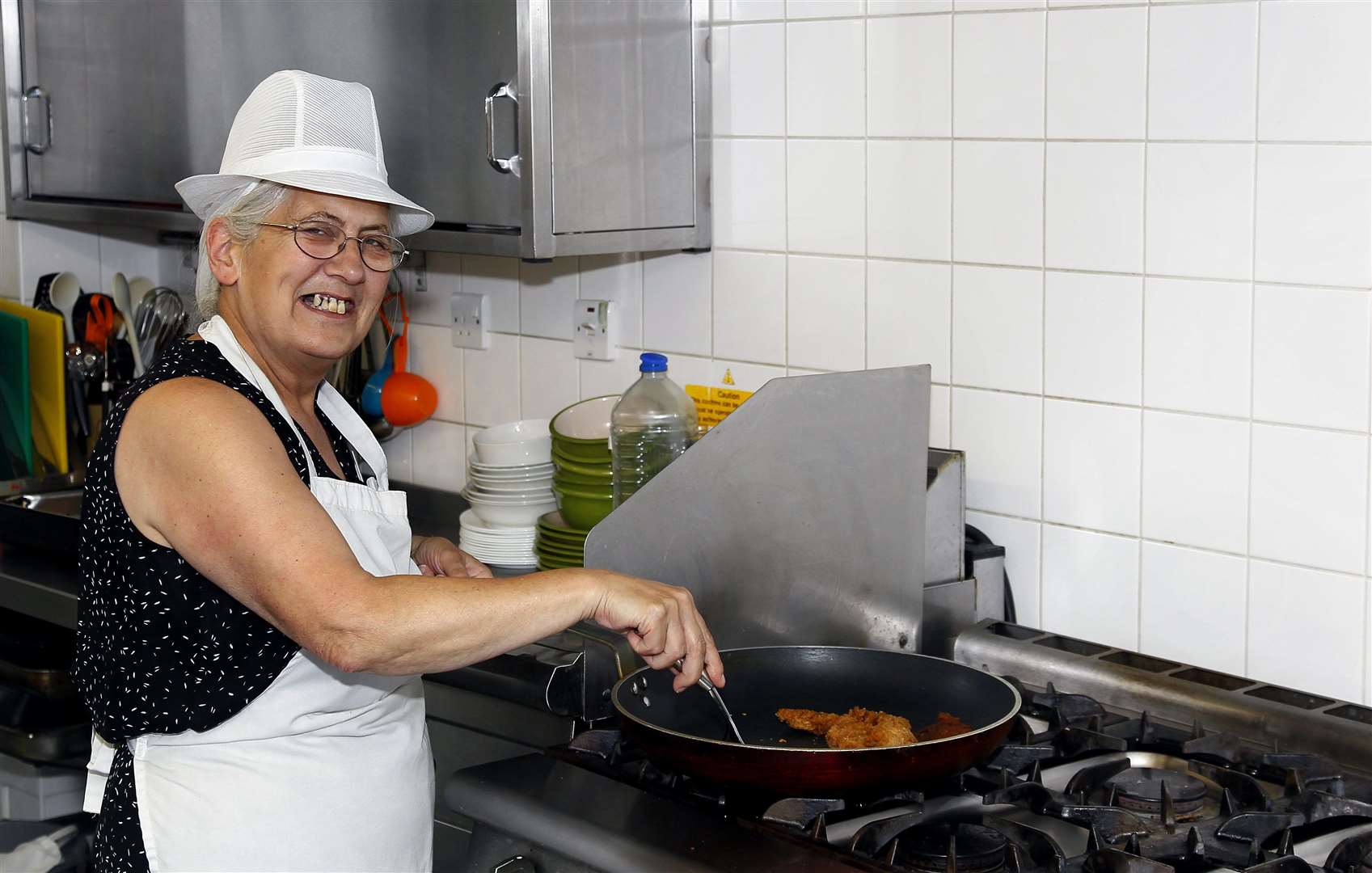 Dee cooks at Maidstone Day Centre, which received more than three vans full of donations from Supermarket Sweep. Picture: Sean Aidan