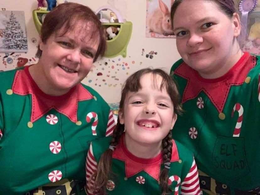 Bella Barton, from Faversham, with her sister Leigh Turner and mum Susan Barton who are fundraising to buy her a football powerchair. Picture: Leigh Turner