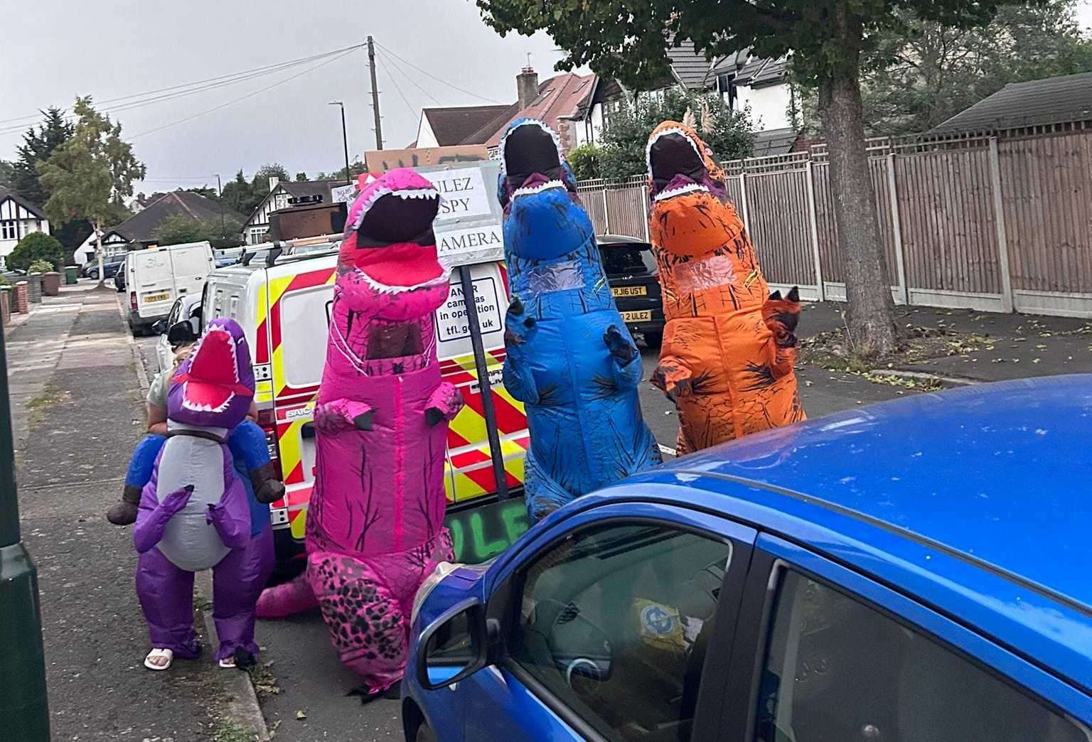 The dinosaur group have different-coloured costumes as they look to block ULEZ cameras. Picture: Paul Sullivan