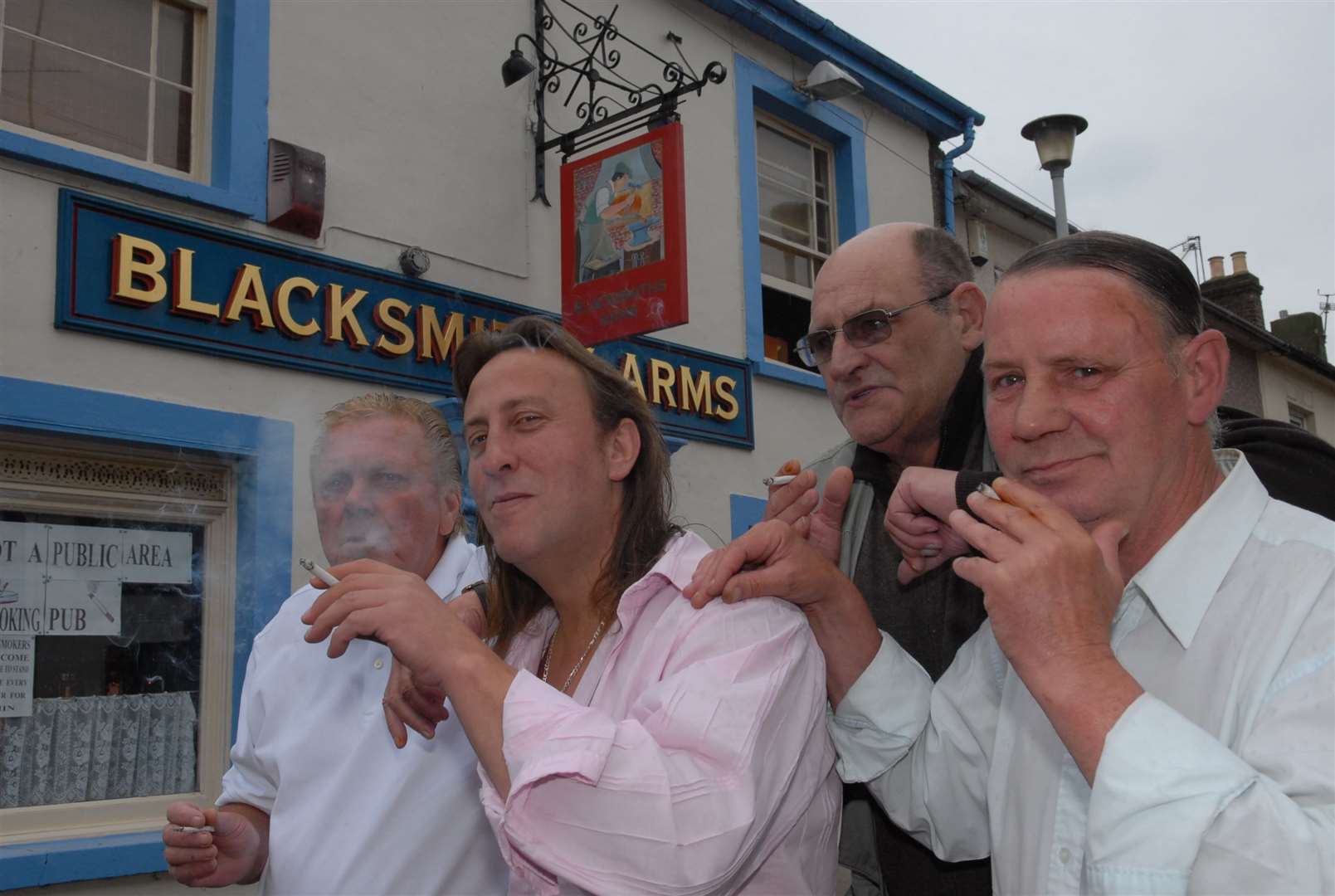 Landlord Mark Hughes of the Blacksmith's Arms, Clyde Street, Sheerness, smokes defiantly in May 2007 outside the pub with regulars Fred Ross, Kenny King and Bob Bailey. The pub closed some timed after 2013 as has been turned into homes. Picture: Mike Smith