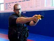 A policeman using a taser gun