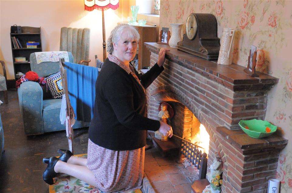 Sue Padgham sorting the fire inside the 1940s 'house'