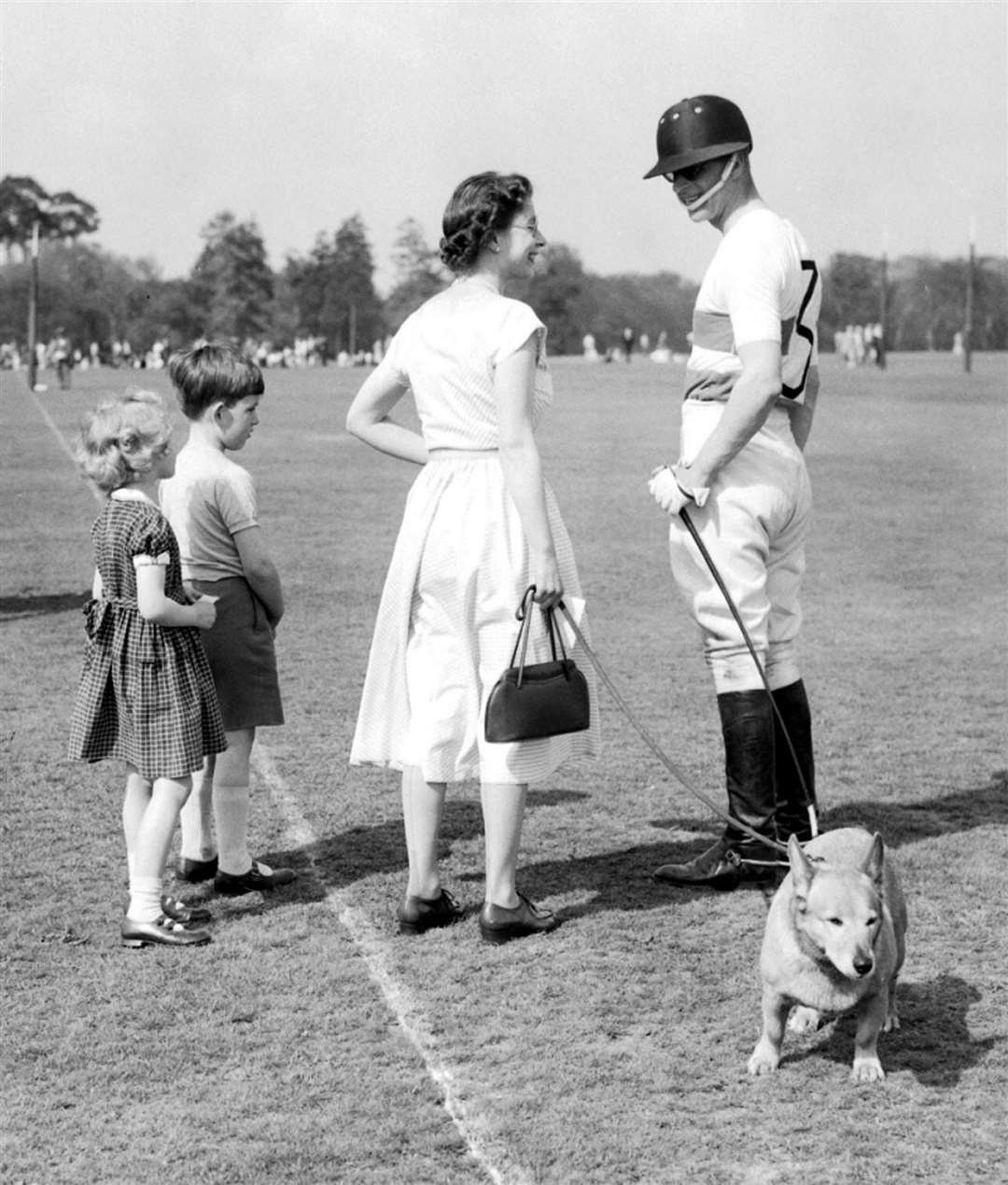 The Queen with one of the dogs and the Duke of Edinburgh at a polo event in Windsor Great Park (PA)