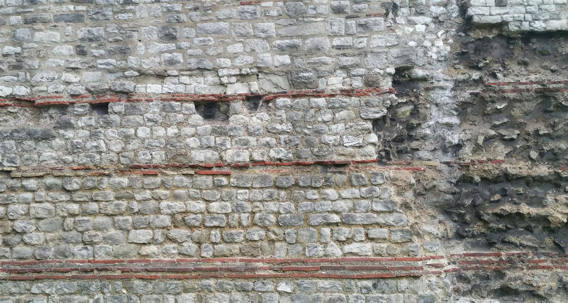 Finely worked ragstone blocks visible in this section of the Roman land wall of London near Tower Hill tube station, all transported from the quarries in the upper Medway Valley