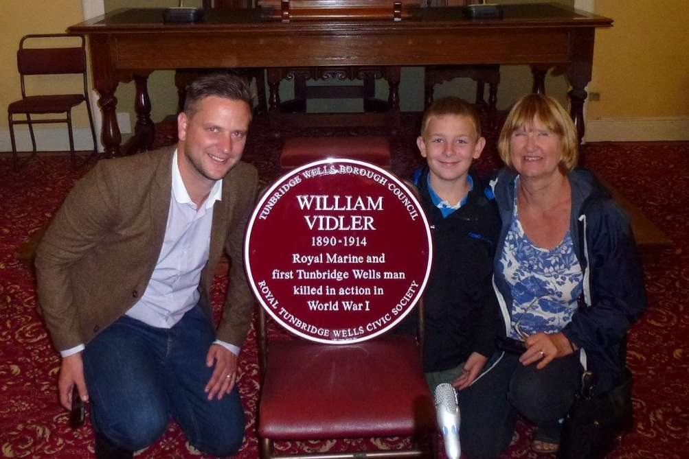 Gareth Vidler with his nephew and mum next to the plaque for Private William Vidler