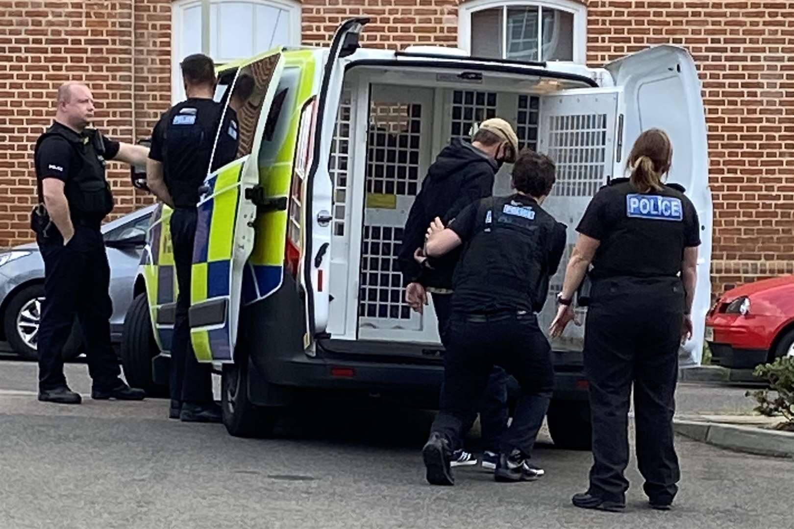 A man was escorted into a police van