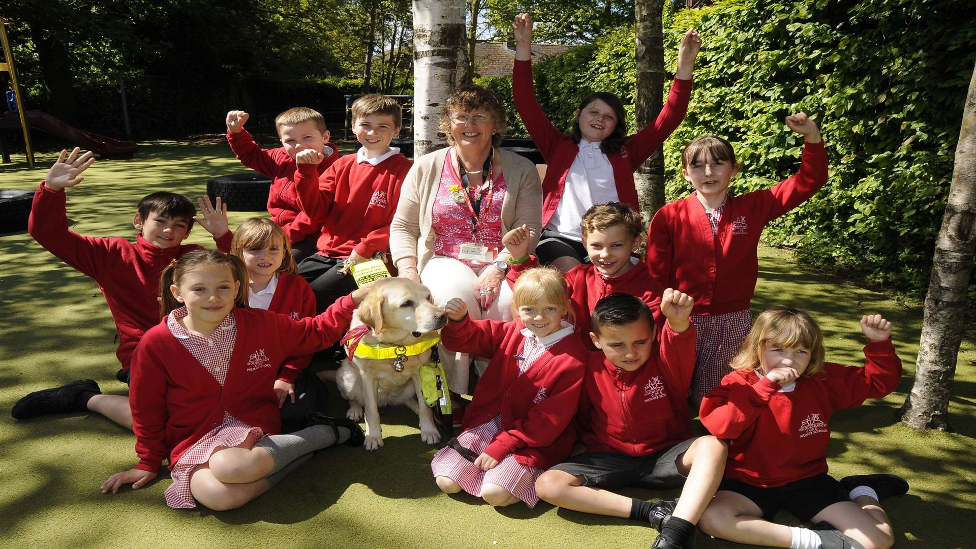 Pat Marshall with her guide dog Chloe and pupils from Woodchurch Primary School.