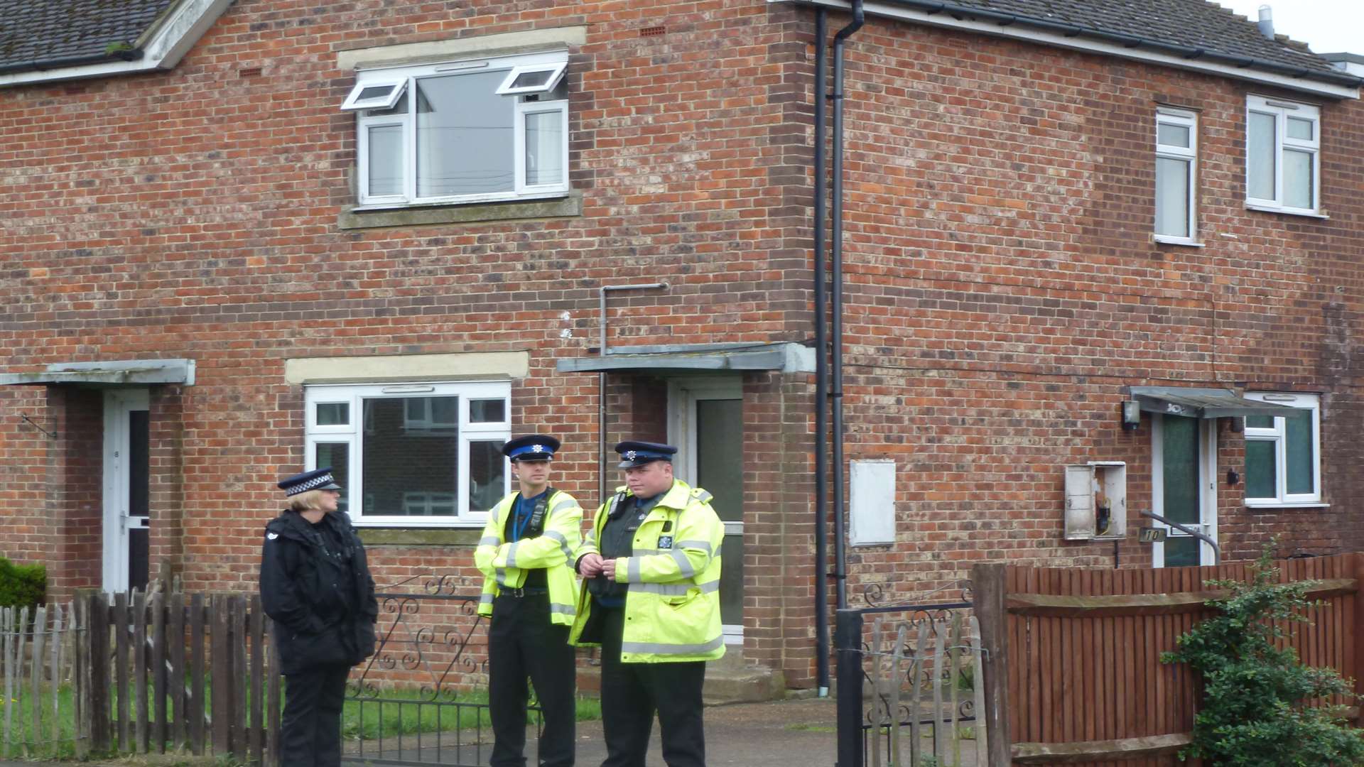 Officers guard a house after an armed raid. Picture: Matt Leclere