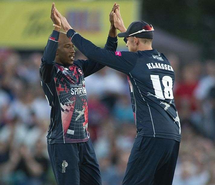 Daniel-Bell Drummond and Fred Klaassen celebrate a wicket against Surrey Picture: Ady Kerry