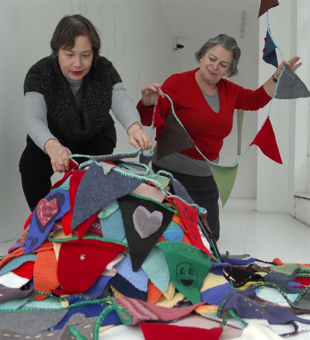 Clare Smith, left, and Joanna Jones, of DAD, initiating community workshops to create one mile of bunting to hang in the town to welcome the Olympic Torch for the London 2012 Games.