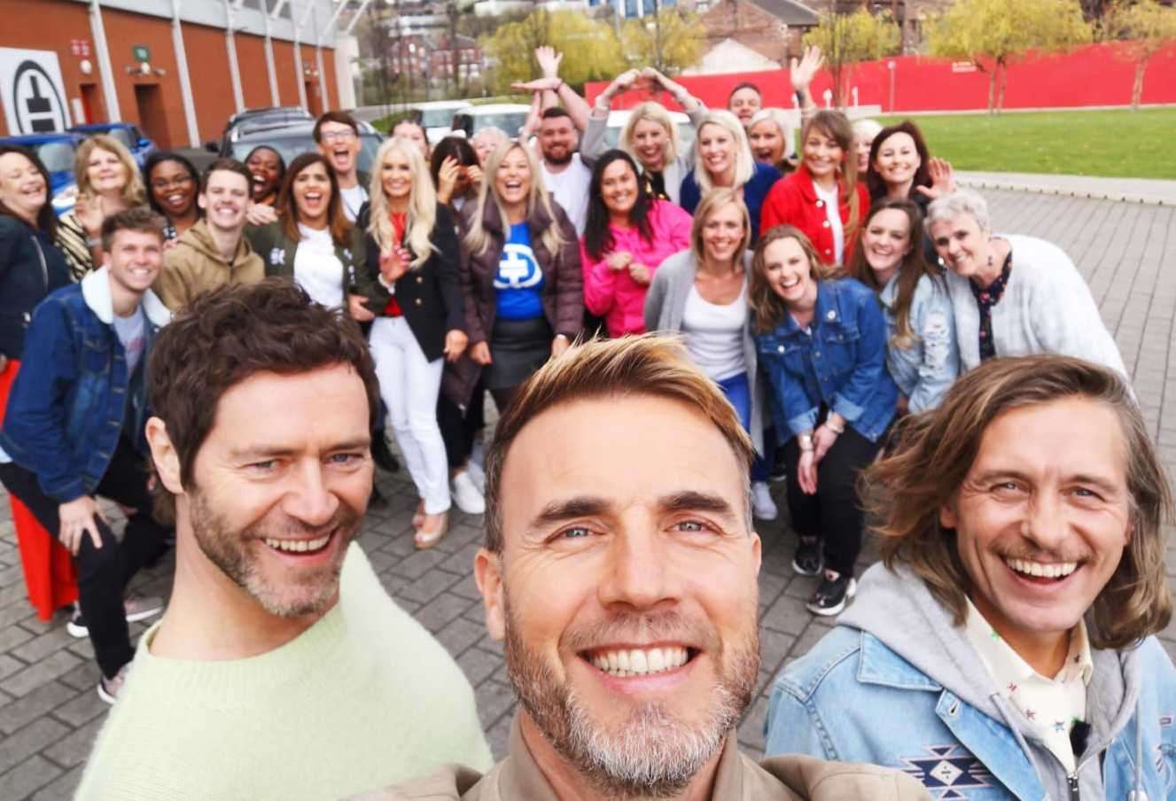 Take That's Howard Donald, Gary Barlow and Mark Owen with their fans