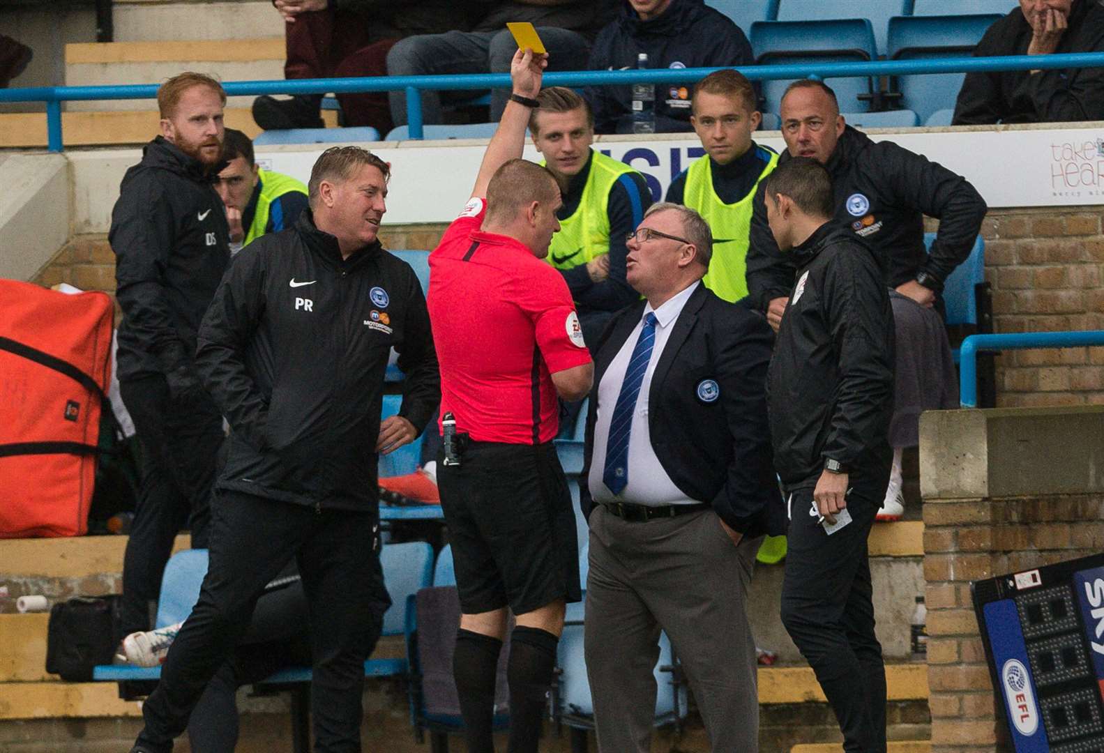 Steve Evans is booked by referee Lee Swabey when Peterborough played at Priestfield earlier this season Picture: Ady Kerry