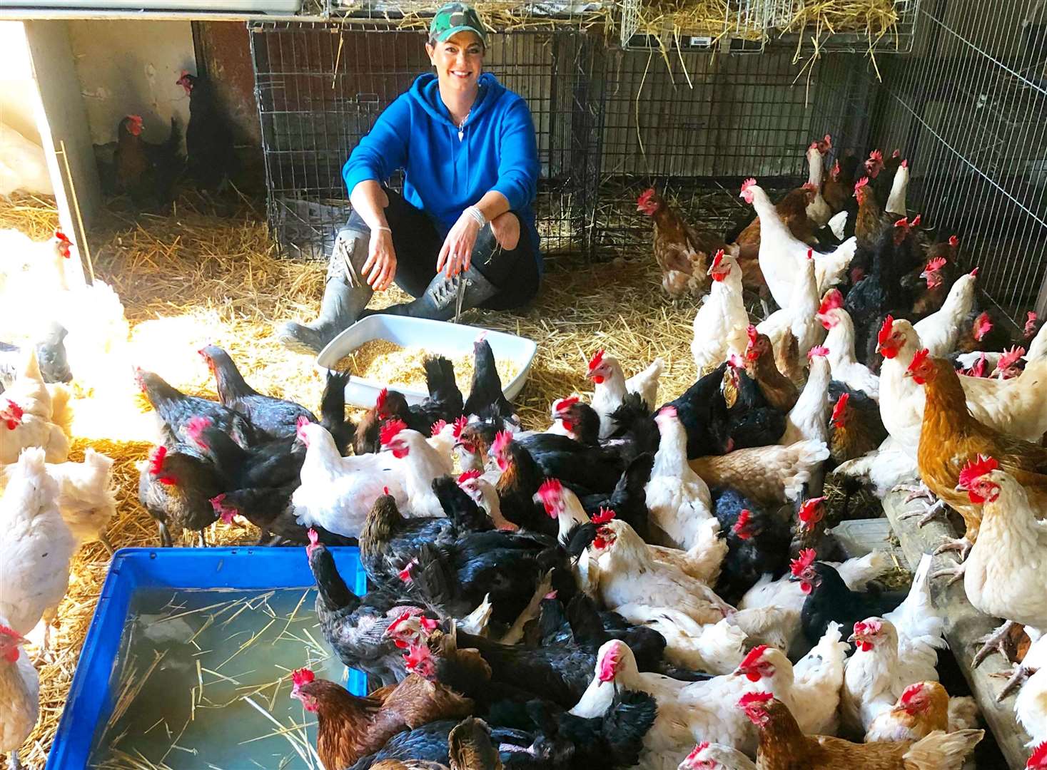 Happy Pants Ranch founder Amey James with dozens of chickens she rescued previously