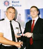 John Blissett receives his award from Ch Supt Peter West