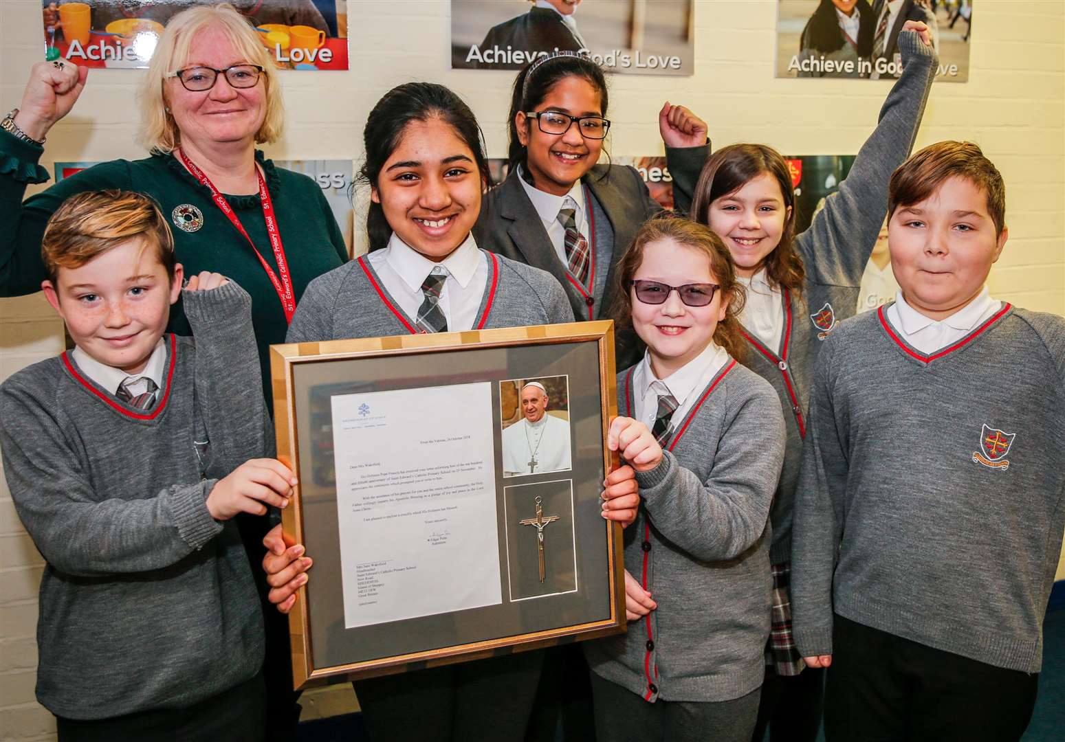 Head teacher at St Edwards Catholic Primary School, Sara Wakeford, with pupils Alex, Iqra, Naomi, Veronica, Demi-Leigh and David with their letter from Pope Francis