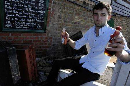Luke Gillam, manager of East Quay restaurant in Whitstable, with sauce bottles in a safe bungling thieves tried to steal