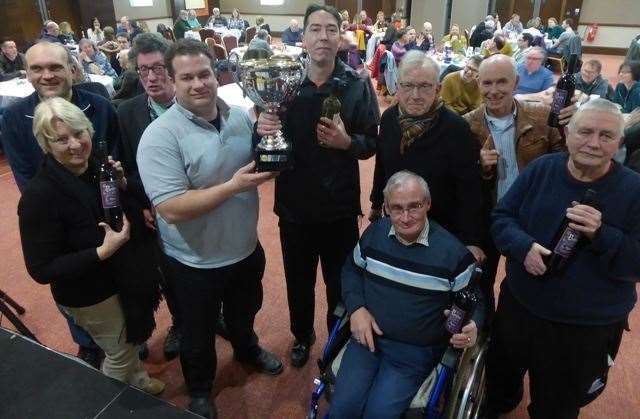 Phil Wilson, in grey top, from IMP presents the champions trophy to Supernova at the 2018 Big Quiz final (11802618)