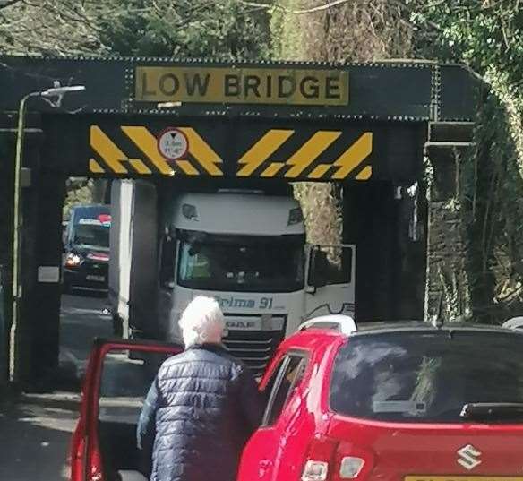 A car passenger views the lorry stuck fast under the bridge. Picture: Kelsey Santer