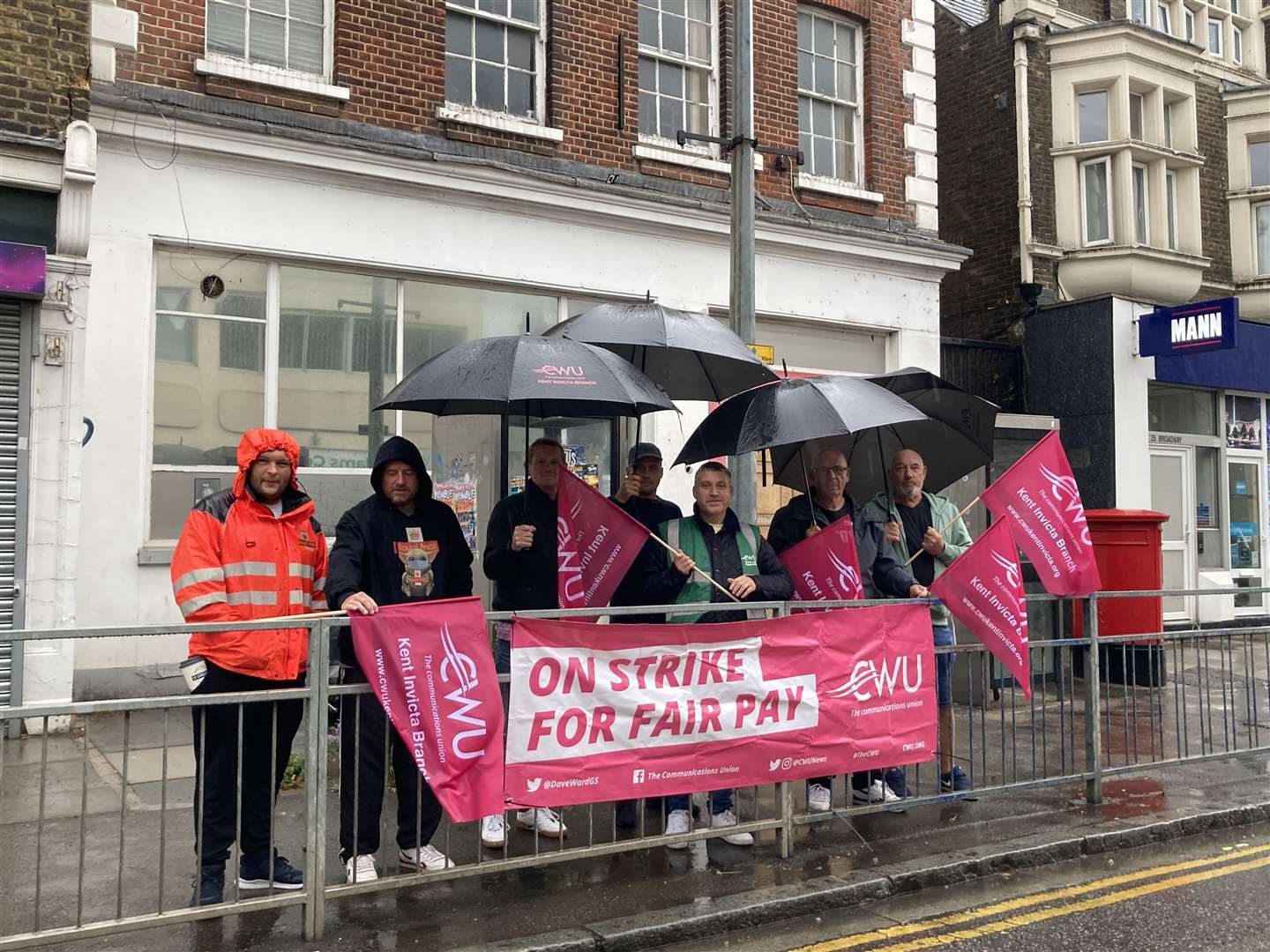 Communication Workers Union pickets striking in the rain outside the Royal Mail's depot in Sheerness Broadway on September 8. Picture: John Nurden